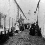 An old photograph of a cobblestone street in Keswick