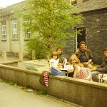 A family relax in the courtyard on a sunny Lake District day
